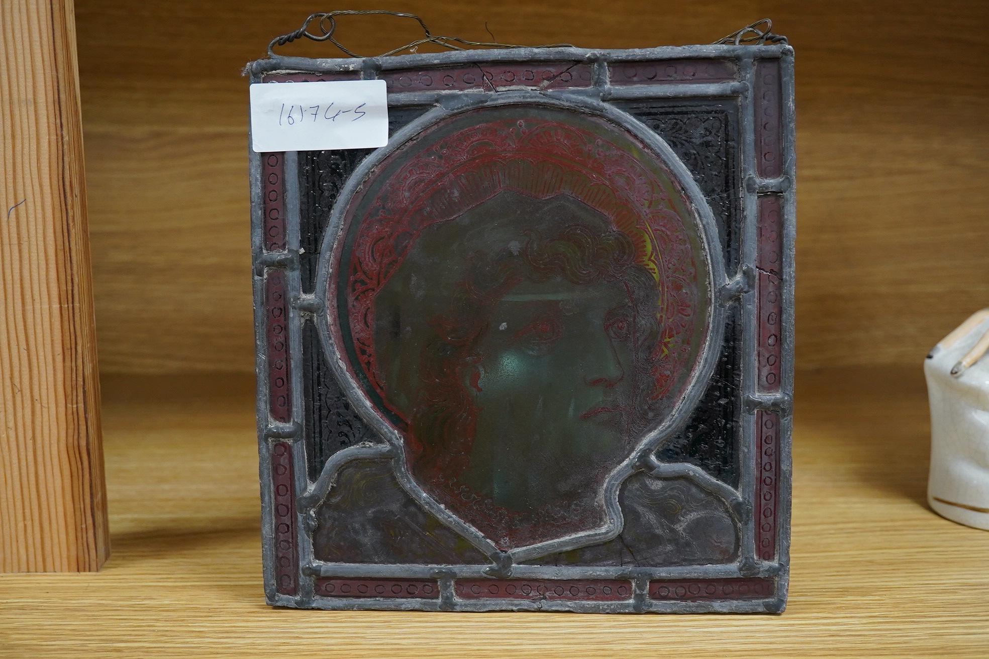 A stained glass panel showing the head of a saint, 21 x 20cm. Condition - four panels cracked